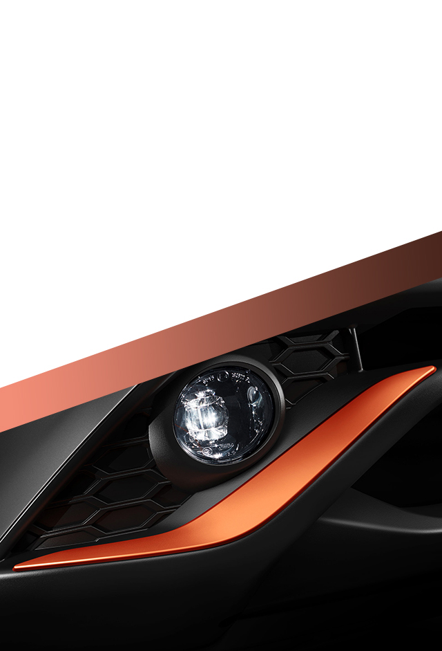 Het nieuwe Nissan JUKE detail van de energy orange afwerking op de voorbumper